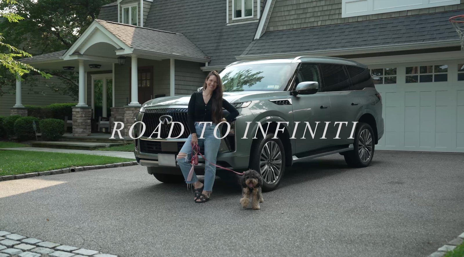 Dana with her INFINITI QX80 and dog in her driveway, Road to INFINITI