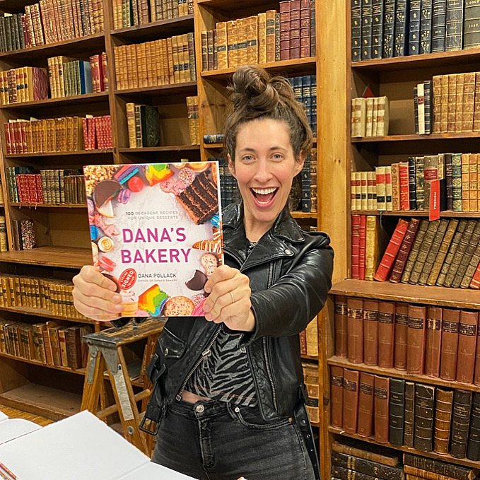 Dana holding the Dana's Bakery cookbook on launch day